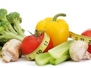 Vegetables with tape measure around them