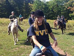 Several WVU students on horseback